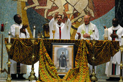 Father Oscar Anguiano, the principal celebrant, elevates the Eucharist as Father Kenneth Taylor, from left, Father Steve Schwab, Father Eusebius Mbidoaka and Father William Munshower, not shown, concelebrate the feast day Mass in memory of St. Martin de Porres on Nov. 3 at St. Rita Church in Indianapolis.