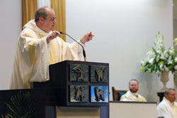 Benedictine Father Denis Robinson, the new president-rector of Saint Meinrad School of Theology in St. Meinrad, preaches a homily on June 8 at the Mass of Thanksgiving of newly ordained Father Joseph Newton at Our Lady of the Greenwood Church in Greenwood. In the background are, from left, Father Newton and Msgr. Mark Svarczkopf, pastor of Our Lady of the Greenwood Parish. (Photo by Sean Gallagher)