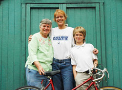 Maureen McLean, left, Stephanie Singleton and Austin Busone of Holy Cross Parish in Indianapolis work together to collect donated adult bicycles for homeless people. The bikes help the homeless people get to jobs, medical appointments and even college classes. (Photo by John Shaughnessy)