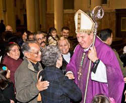 After celebrating Mass at his home parish, Holy Redeemer Church in Detroit, on Nov. 25, 2010, Archbishop Joseph W. Tobin stands in the church’s main aisle greeting parishioners for more than a half-hour. Archbishop Tobin was baptized at the church and was its pastor for several years after being ordained a priest. (Photos by Larry A. Peplin, The Michigan Catholic)