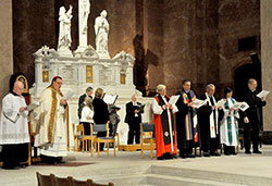 Archbishop Joseph W. Tobin, second from left, Episcopal Bishop Catherine Waynick, Rev. Richard Spleth, regional minister of the Christian Church (Disciples of Christ), Rev. Dr. Robert Welsh, ecumenical officer of the Christian Church (Disciples of Christ), Rev. Heather Apel of the Indiana-Kentucky Synod of the Evangelical Lutheran Church of America, and Father Rick Ginther, director of the archdiocesan Offiice of Ecumenism, sing a hymn during an ecumenical prayer service on Jan. 25 at SS. Peter and Paul Cathedral in Indianapolis. Also assisting in the service are master of ceremonies Loral Tansy, left, and members of Laudis Cantores, the cathedral’s choir. (Photos by Sean Gallagher)