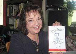 St. Mark the Evangelist School teacher Evelyn Karozos is pictured with a copy of her book, There’s a Spider in Your Hair (and other classroom vignettes). (Submitted photo)