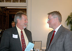 Business owner Jim Huntington, left, talks with Marian University president Daniel Elsener during a break at a Catholic Charities Indianapolis poverty summit at the college on Feb. 24. (Photo by John Shaughnessy)