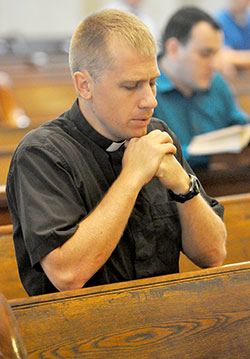 Transitional Deacon Anthony Hollowell is deep in prayer during the archdiocesan seminarian retreat on Aug. 11, 2015, at St. Mary Church in New Albany. (Photo by Sean Gallagher)