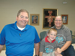 Harold, Gus and Kathy Ducote have found a home—and a place to live their faith—at SS. Francis and Clare of Assisi School in Greenwood. (Photo by John Shaughnessy) 