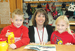 Janice Narwold, second-grade teacher at St. Louis School in Batesville, shares a smile with two of her students, Ray Walke and Madi Dierckman. (Photo by John Shaughnessy)