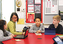 As the director of support services at St. Monica School in Indianapolis, Christine Exline leads a session with Elena Rosario, Jordan Mink and Teddy Isakson. (Submitted photo)