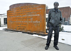 Abie Robinson, senior program coordinator for Indianapolis Parks and Recreation, stands on March 26 before a new memorial in Kennedy King Park in Indianapolis. The memorial pays tribute to a speech given by Robert F. Kennedy in the park on April 4, 1968, the day Rev. Martin Luther King Jr., was assassinated. Robinson attended the speech. (Photo by Sean Gallagher)