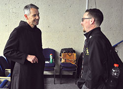 Benedictine Brother John Mark Falkenhain, left, speaks on Oct. 25 with archdiocesan seminarian Liam Hosty in the auditorium of the Mother Theresa Hackelmeier Memorial Library at Marian University in Indianapolis. A licensed clinical psychologist who has researched clergy sexual abuse, Brother John Mark gave a presentation that day on the current clergy sexual abuse crisis in the Church. (Photo by Sean Gallagher)