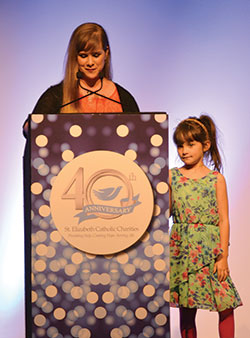 During the St. Elizabeth Catholic Charities “Giving Hope, Changing Lives” gala on April 25 in Louisville, Ky., Ariel LaGrange, left, shares the story of how the New Albany agency helped her and her daughter Ava Isabella, right. (Photos by Natalie Hoefer)