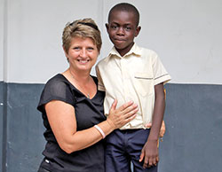 Chris Schwartz, a member of St. Bartholomew Parish in Columbus and middle school religion teacher at the parish’s school, poses with Louvenyz Bouchette in 2016 during a mission trip to Limonade, Haiti. (Submitted photo) 