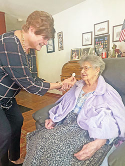 As an extraordinary minister of holy Communion for St. Patrick Parish in Terre Haute, Betty Kapellusch shares the Eucharist with Betty Seprodi, a member of the parish for 73 years, during her weekly visit with Seprodi. (Submitted photo)