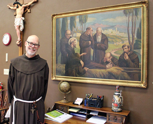 Franciscan Father John Barker poses in the friary at Holy Family Parish in Oldenburg, where he has served as pastor since being ordained a priest there on Aug. 24. (Submitted photo by Jennifer Lindberg)