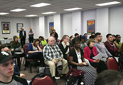 Students and staff listen to the keynote speech, "Can you Hear The Eco? Relationships: A Good Planet is Hard to Find," by Precious Blood Father Kevin Scalf based upon Pope Francis' encyclical "Laudato Si'," as the Humanities Festival opened April 4 at Calumet College of St. Joseph. (Marlene A. Zloza photo)