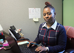 Stephanie Miller, the parish community outreach coordinator at Catholic Charities of the Diocese of Gary, works in the Hammond office after returning in late November from serving a two-week stint with the Catholic Charities USA National Disaster Response Team in the Diocese of Raleigh, North Carolina to help flood victims. (Marlene A. Zloza photo)